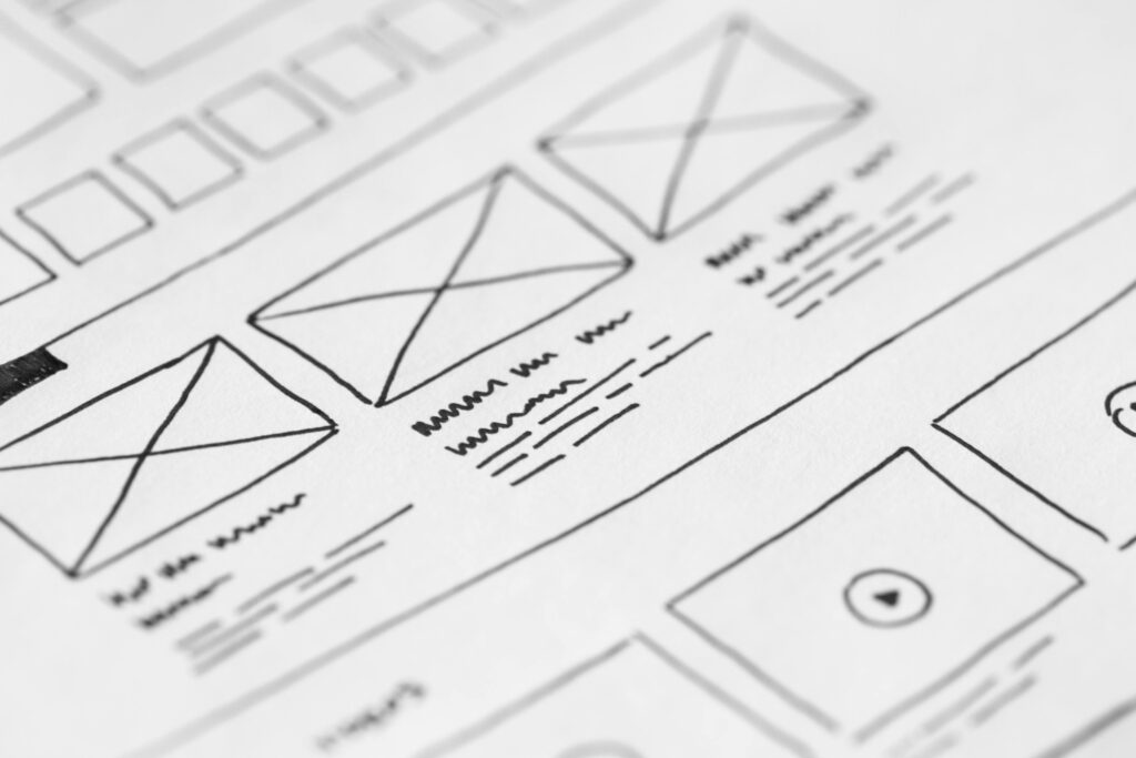 wireframesui Detailed close-up of a hand-drawn wireframe design on paper for a UX project.